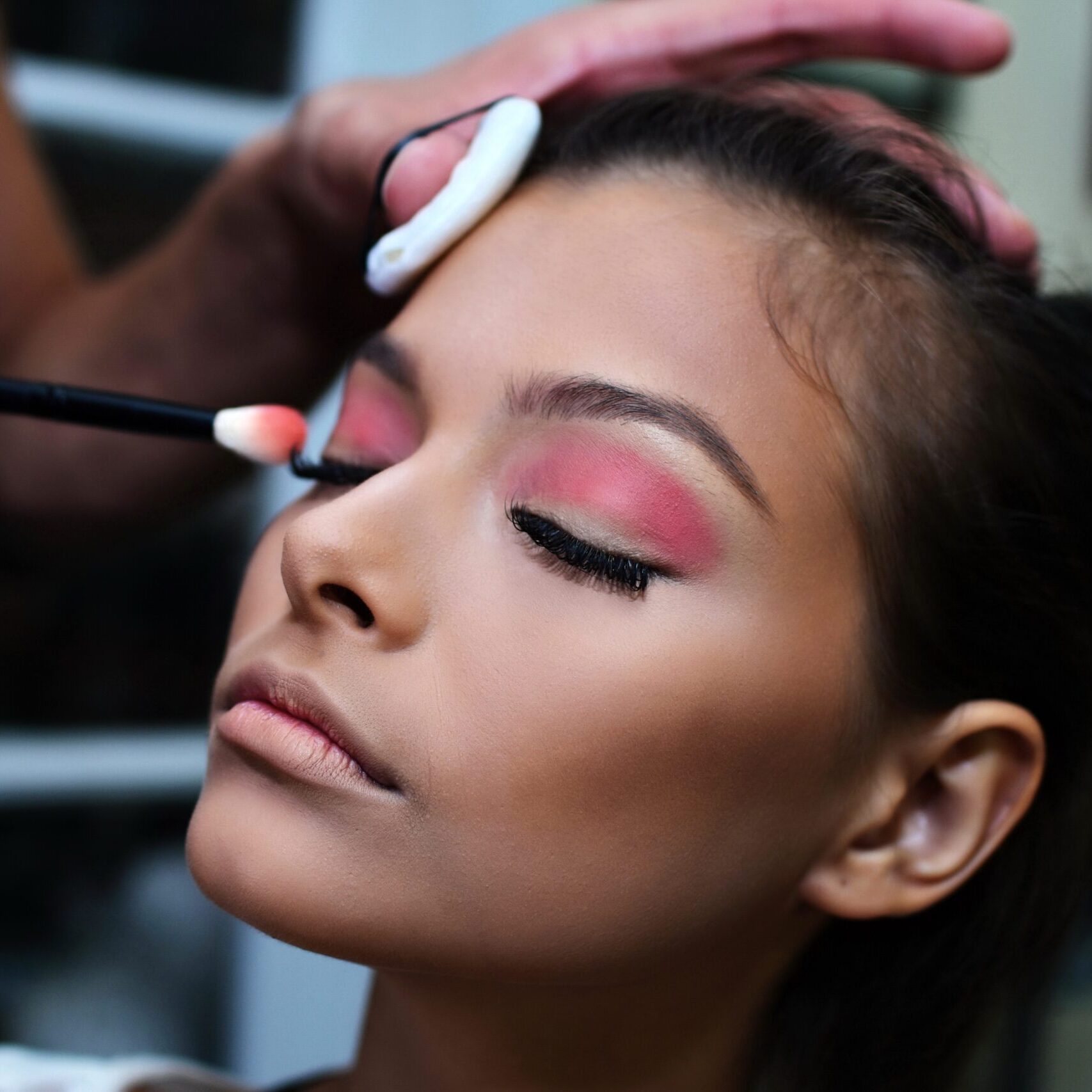 Makeup artist doing eye lash makeup